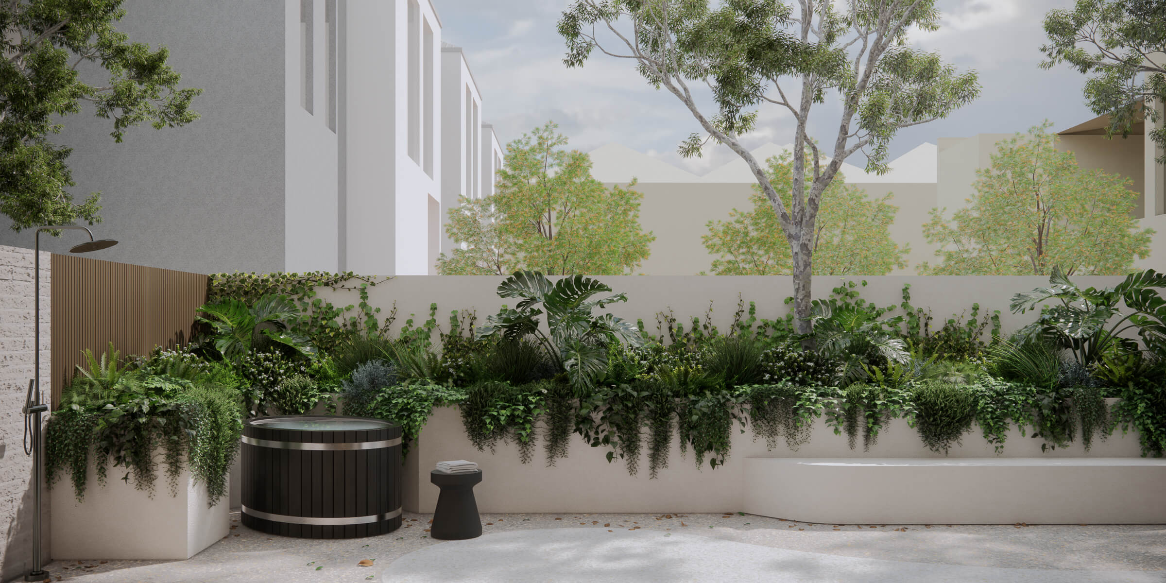 Modern outdoor patio with lush green plants along a white wall, a round cold plunge tub, a small black stool with folded towels, and a wall-mounted showerhead.
