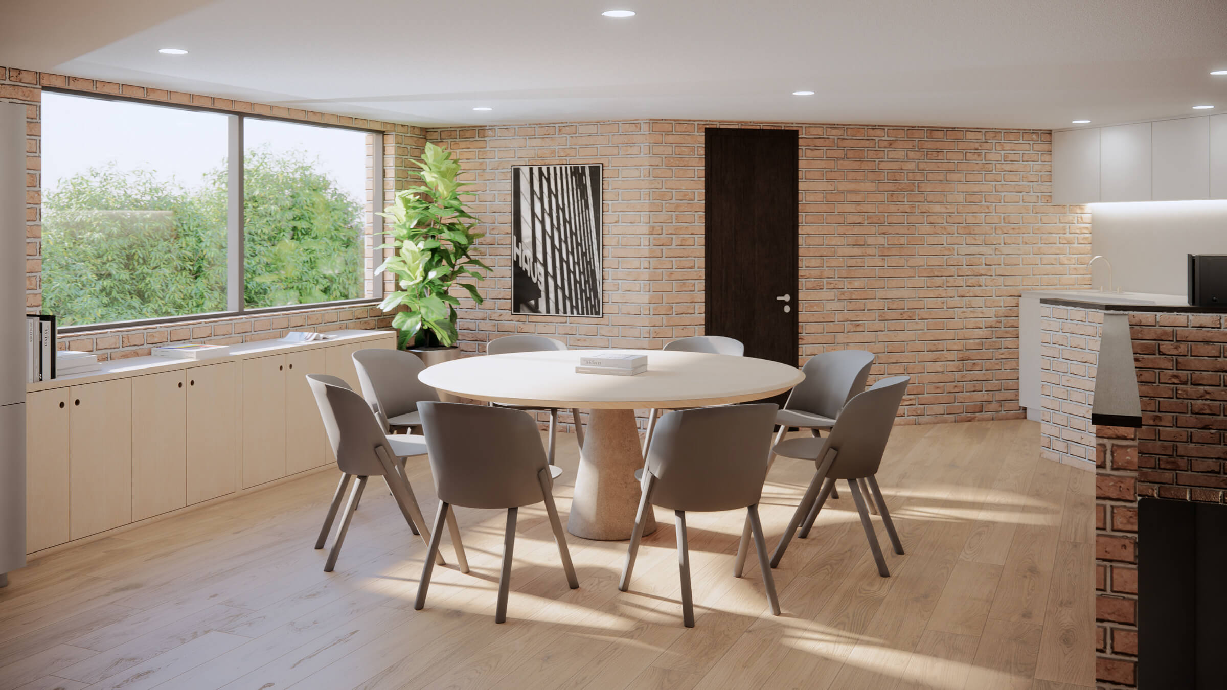 Modern office meeting area with round table, seven gray chairs, large window with greenery outside, brick walls, and wooden floor.